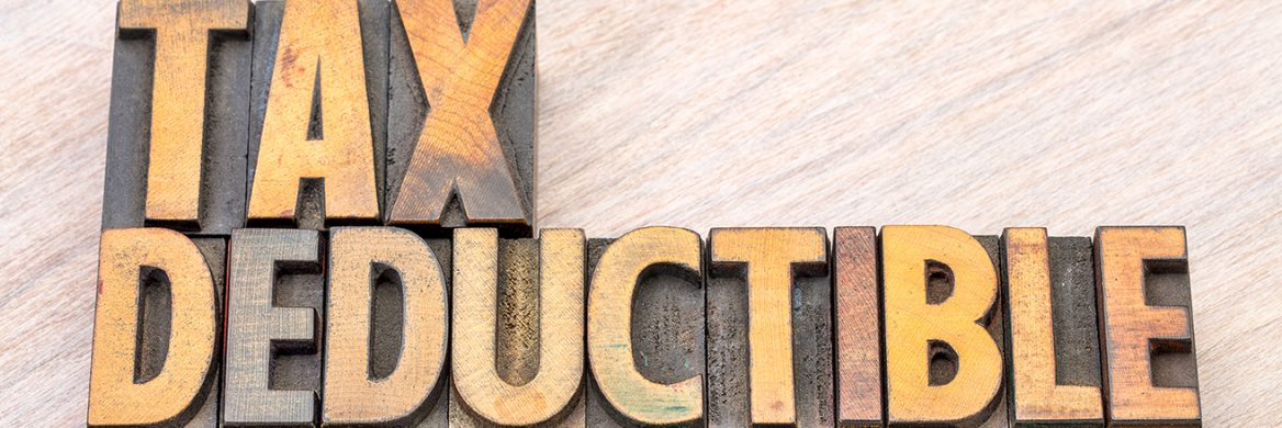 Wooden blocks spell out “Tax Deductible”.