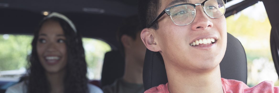 A driver and two passengers in a car.