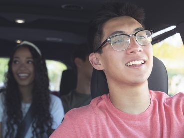 A driver and two passengers in a car.