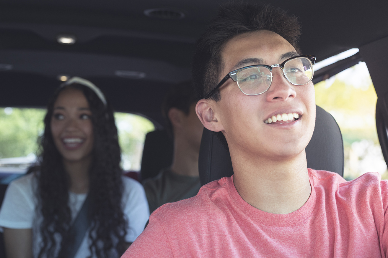 A driver and two passengers in a car.