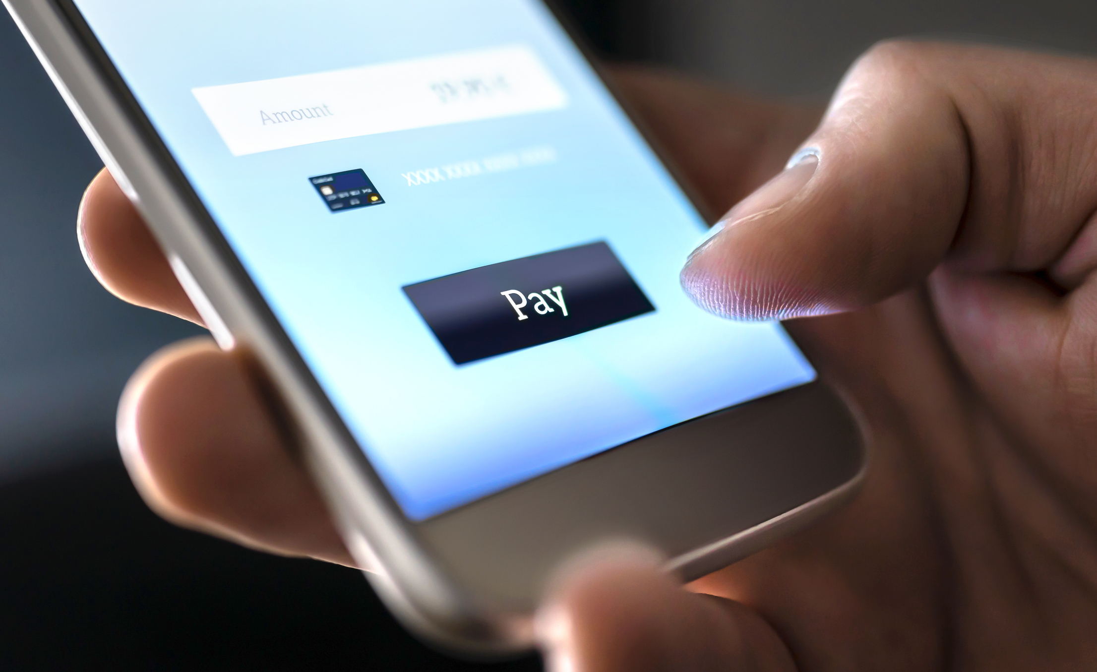 A person makes a payment with their smartphone.