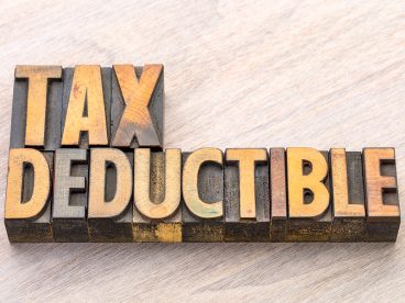 Wooden blocks spell out “Tax Deductible”.