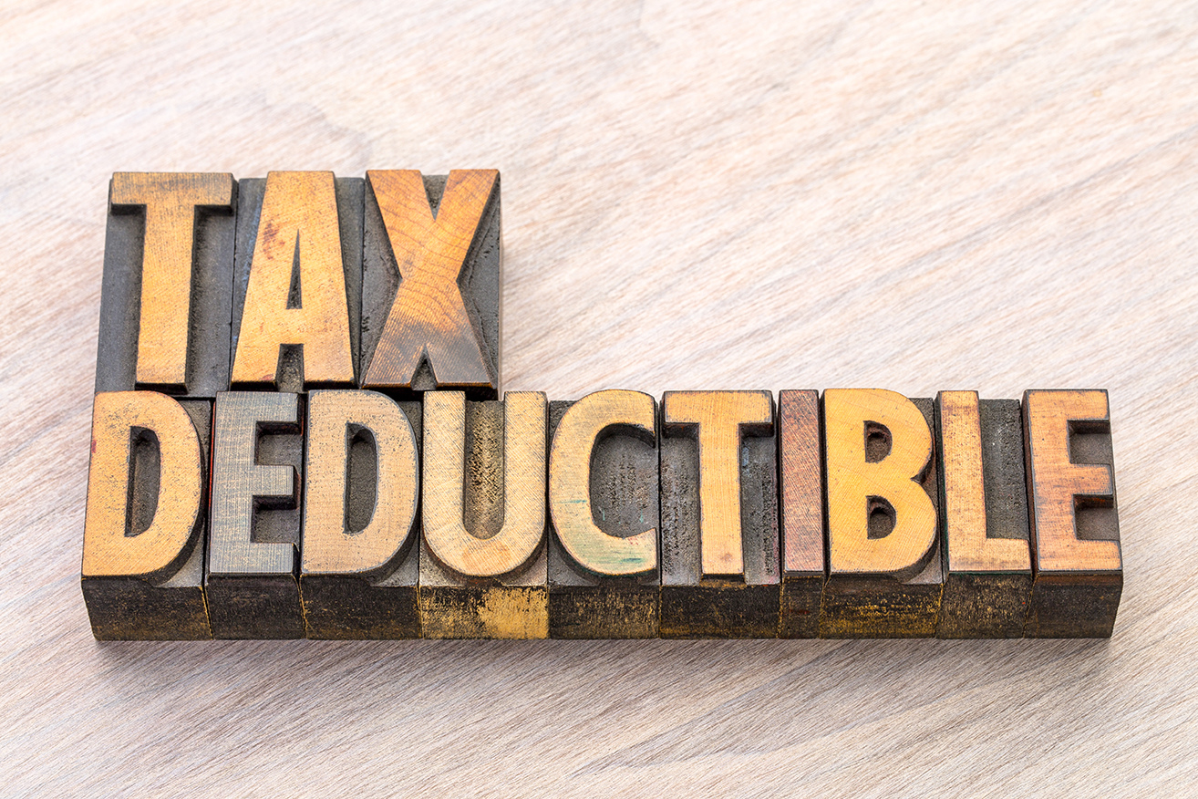 Wooden blocks spell out “Tax Deductible”.