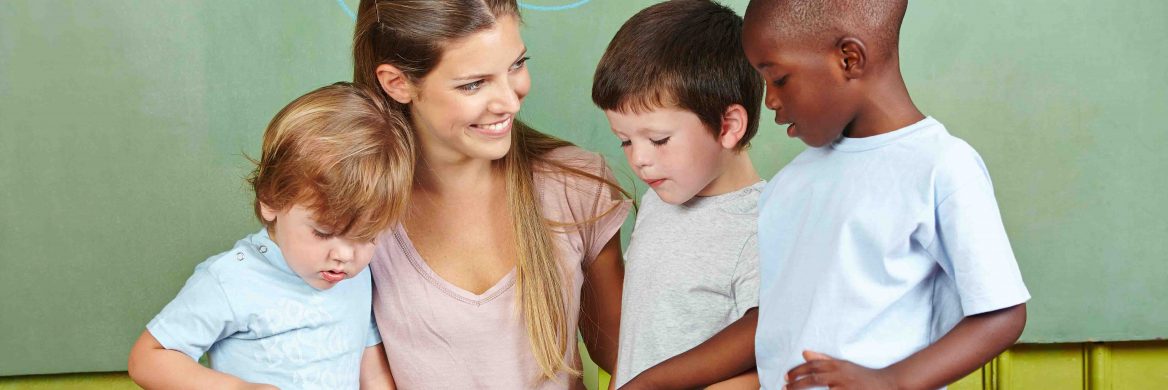 Three children with a childcare worker who helps their families qualify for the Child and Dependent Care Credit.