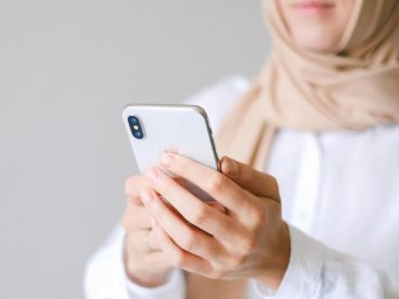 A person looks at their cell phone.